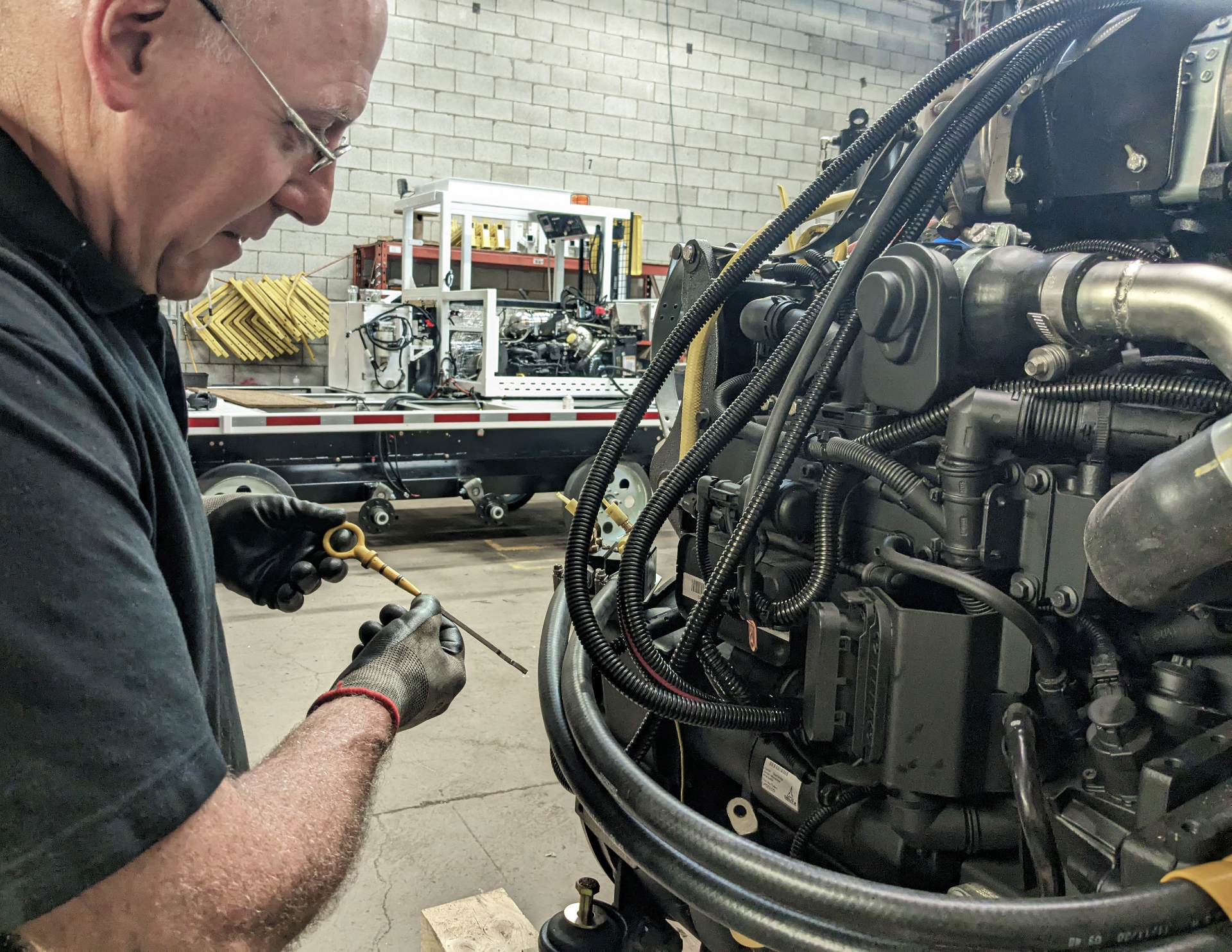 UTV technician checking engine oil during service