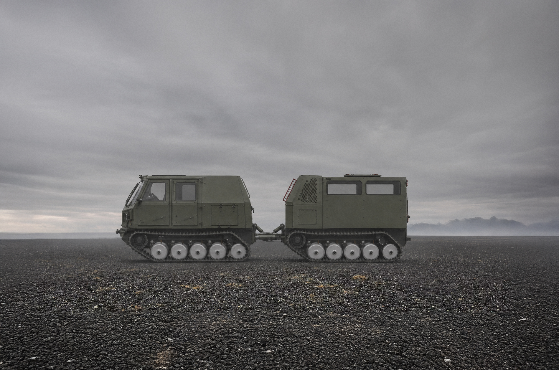 Voyager D12 tracked carrier on open tundra under a wide northern sky