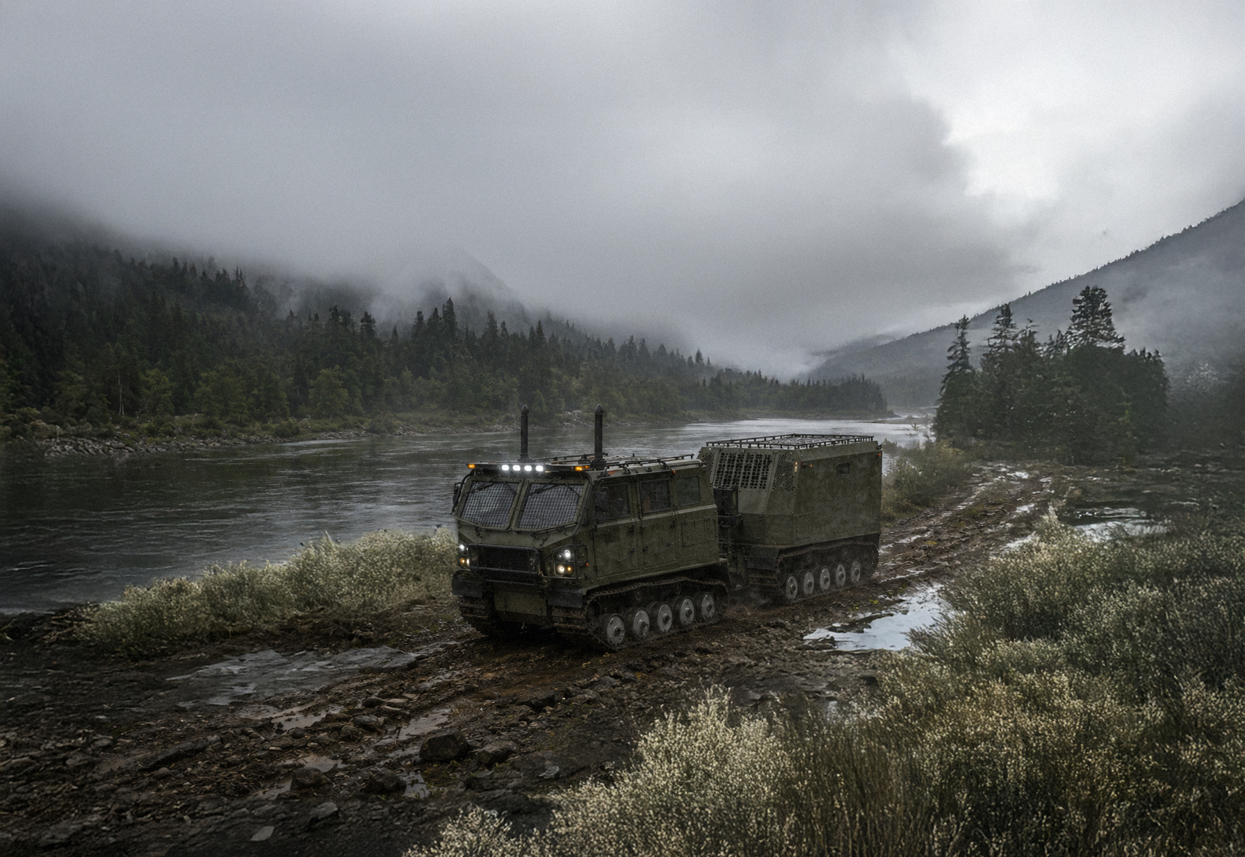 Voyager articulated tracked carrier crossing a riverbank in northern terrain
